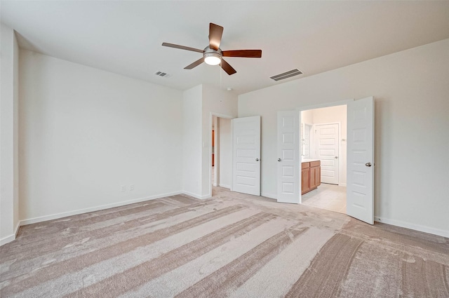 18822 Fulvetta Haven Way, Richmond, TX 77407 - unfurnished bedroom featuring light carpet, ensuite bathroom, and a ceiling fan