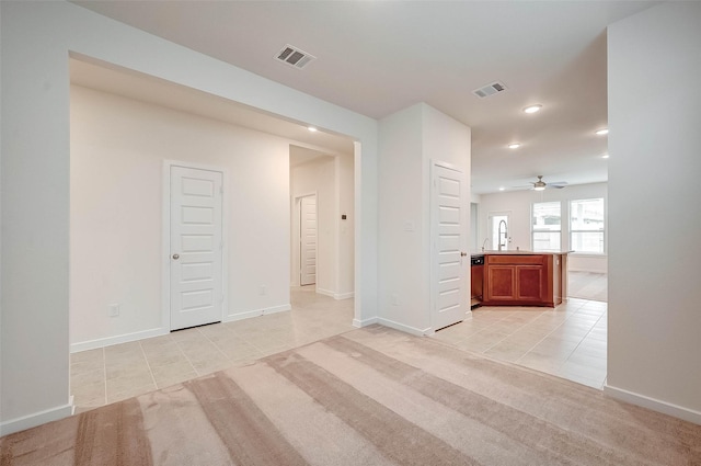 18822 Fulvetta Haven Way, Richmond, TX 77407 - empty room featuring light tile patterned floors, recessed lighting, ceiling fan, and light carpet