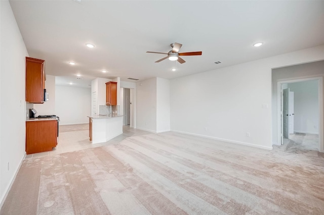 18822 Fulvetta Haven Way, Richmond, TX 77407 - unfurnished living room featuring a ceiling fan, light colored carpet, and recessed lighting