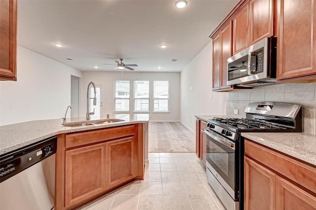 18822 Fulvetta Haven Way, Richmond, TX 77407 - kitchen with appliances with stainless steel finishes, a ceiling fan, recessed lighting, light tile patterned floors, and tasteful backsplash
