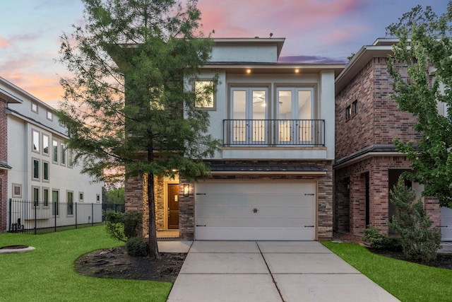 127 Benjis Pl, The Woodlands, TX 77380 - view of front of property with a garage, concrete driveway, stucco siding, and stone siding