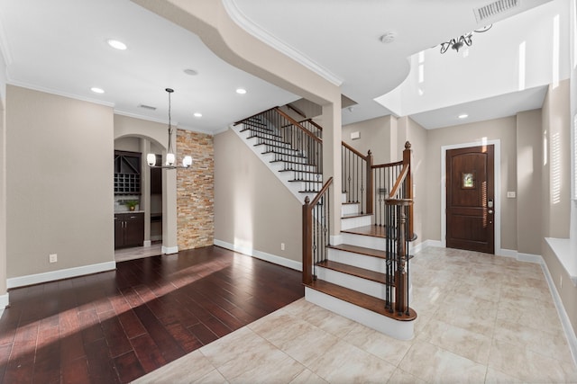 127 Benjis Pl, The Woodlands, TX 77380 - foyer entrance featuring a chandelier, stairs, ornamental molding, recessed lighting, and wood finished floors