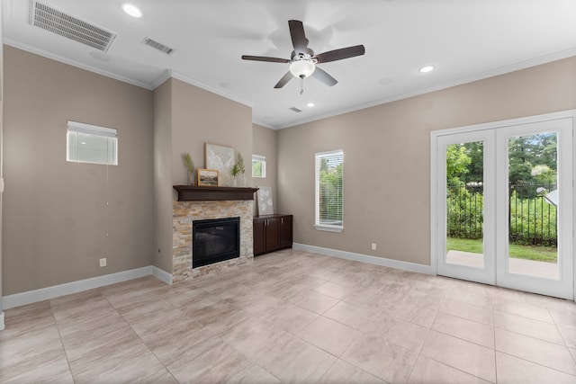 127 Benjis Pl, The Woodlands, TX 77380 - unfurnished living room featuring a stone fireplace, ornamental molding, recessed lighting, a ceiling fan, and light tile patterned flooring