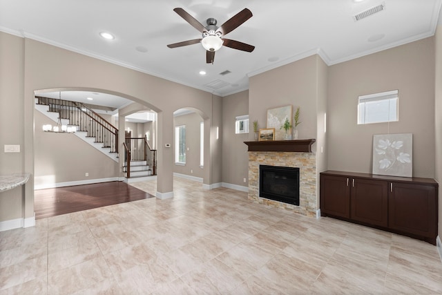 127 Benjis Pl, The Woodlands, TX 77380 - unfurnished living room with stairway, crown molding, plenty of natural light, ceiling fan, and arched walkways