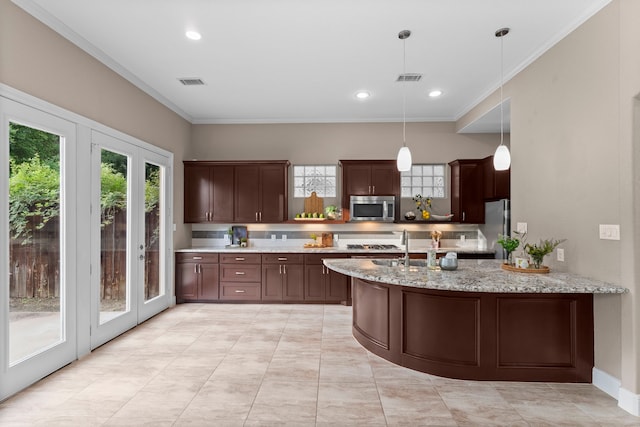 127 Benjis Pl, The Woodlands, TX 77380 - kitchen with appliances with stainless steel finishes, crown molding, decorative light fixtures, tasteful backsplash, and dark brown cabinets