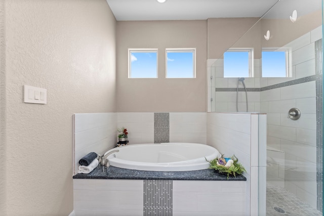 127 Benjis Pl, The Woodlands, TX 77380 - full bath with healthy amount of natural light, a bath, and a shower stall