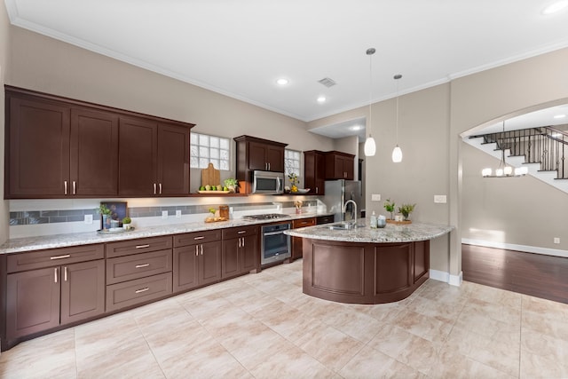 127 Benjis Pl, The Woodlands, TX 77380 - kitchen featuring stainless steel appliances, ornamental molding, dark brown cabinets, pendant lighting, and light stone counters