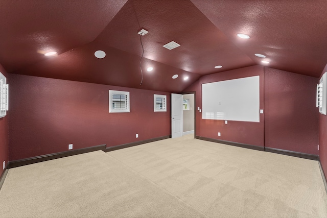 127 Benjis Pl, The Woodlands, TX 77380 - home theater room featuring lofted ceiling, carpet flooring, a textured ceiling, and recessed lighting