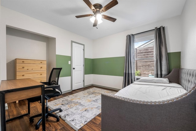 5413 Bataan Rd, Houston, TX 77033 - bedroom with an office area, dark wood-style flooring, and a ceiling fan