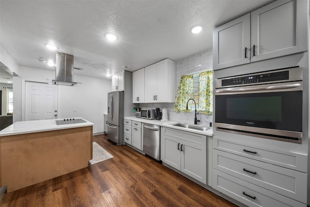 5413 Bataan Rd, Houston, TX 77033 - kitchen with stainless steel appliances, a textured ceiling, light countertops, dark wood-style flooring, and ventilation hood