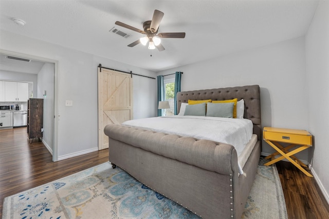 5413 Bataan Rd, Houston, TX 77033 - bedroom featuring wood finished floors, a barn door, and a ceiling fan