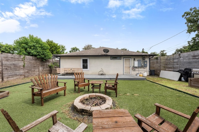 5413 Bataan Rd, Houston, TX 77033 - back of property featuring an outdoor fire pit, a deck, and a fenced backyard