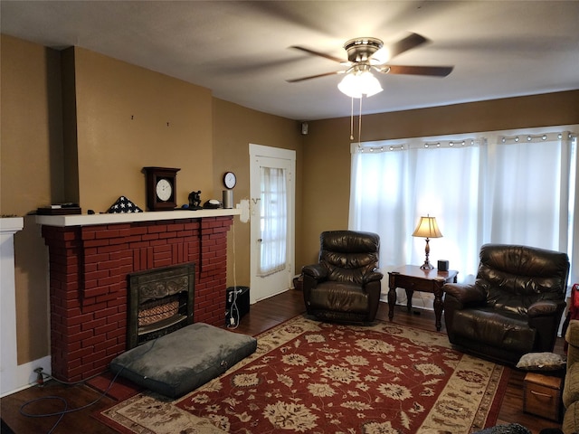 517 Church St, Navasota, TX 77868 - living area featuring a fireplace, a ceiling fan, and wood finished floors