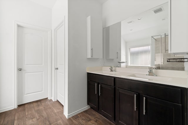20213 Portbec Dr, New Caney, TX 77357 - bathroom with wood finished floors, double vanity, and a shower stall