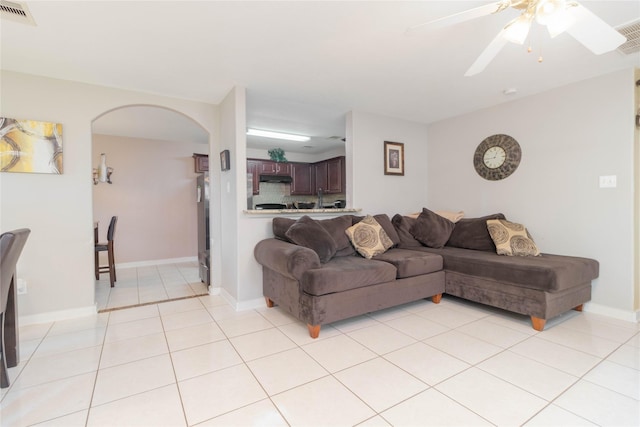 1526 Daffodil Rd, Missouri City, TX 77489 - living room with arched walkways, light tile patterned flooring, and ceiling fan