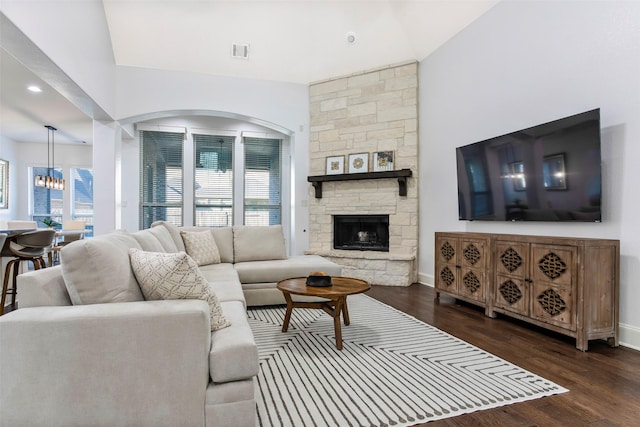 29110 Davenport Dr, Katy, TX 77494 - living area with dark wood-style floors, a chandelier, lofted ceiling, a stone fireplace, and recessed lighting