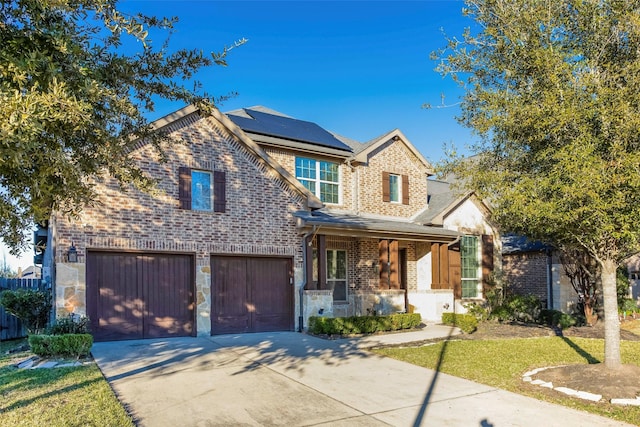 29110 Davenport Dr, Katy, TX 77494 - view of front facade featuring a porch, brick siding, concrete driveway, solar panels, and a garage