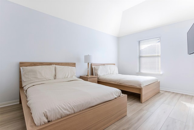 29110 Davenport Dr, Katy, TX 77494 - bedroom featuring light wood-style floors and vaulted ceiling