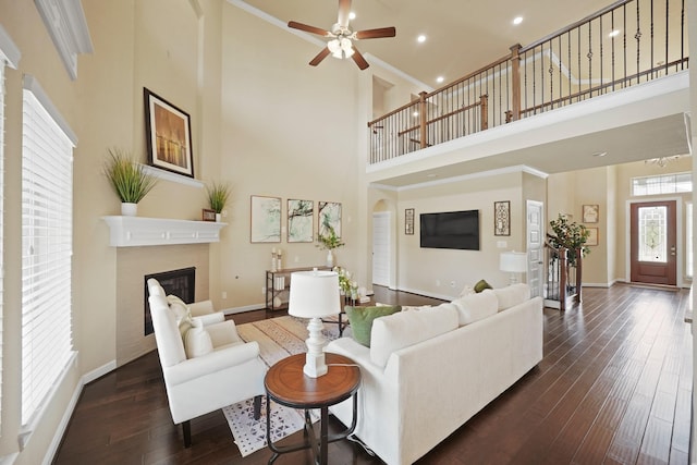 5706 Jenolan Ridge Ln, Sugar Land, TX 77479 - living area featuring a towering ceiling, a glass covered fireplace, dark wood-style floors, a ceiling fan, and recessed lighting