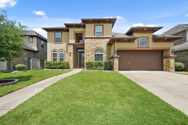5706 Jenolan Ridge Ln, Sugar Land, TX 77479 - view of front of home with stucco siding, stone siding, a front lawn, and driveway