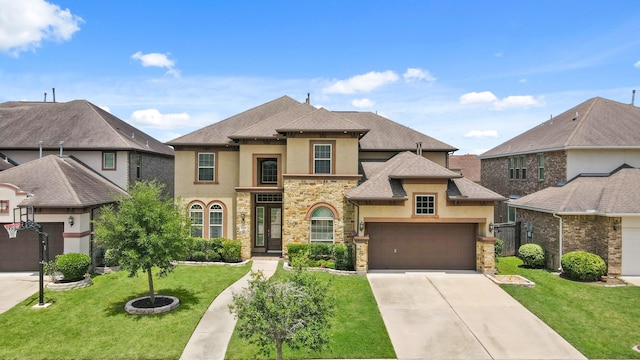 5706 Jenolan Ridge Ln, Sugar Land, TX 77479 - french country home featuring stucco siding, stone siding, concrete driveway, a front lawn, and roof with shingles