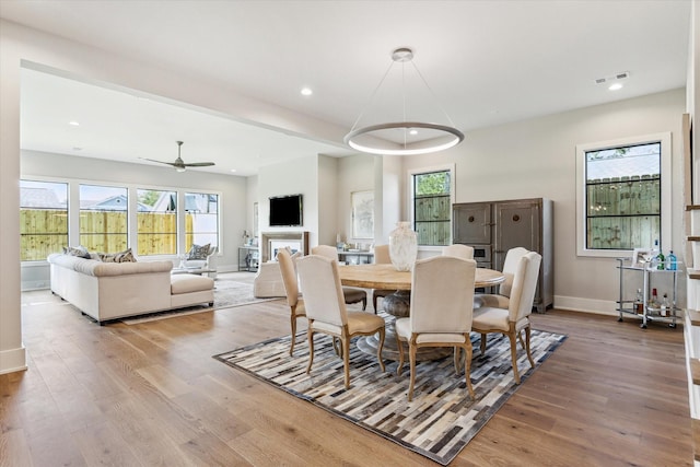 1710 Ebony Ln, Houston, TX 77018 - dining space featuring wood finished floors, ceiling fan, healthy amount of natural light, recessed lighting, and a fireplace