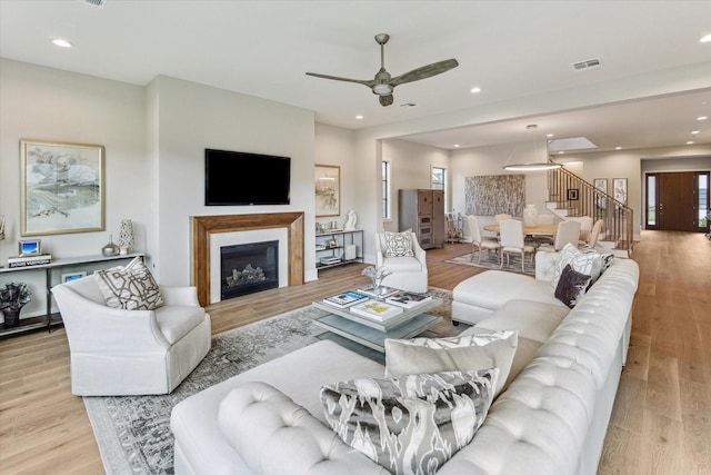 1710 Ebony Ln, Houston, TX 77018 - living area with stairs, wood finished floors, ceiling fan, recessed lighting, and a glass covered fireplace