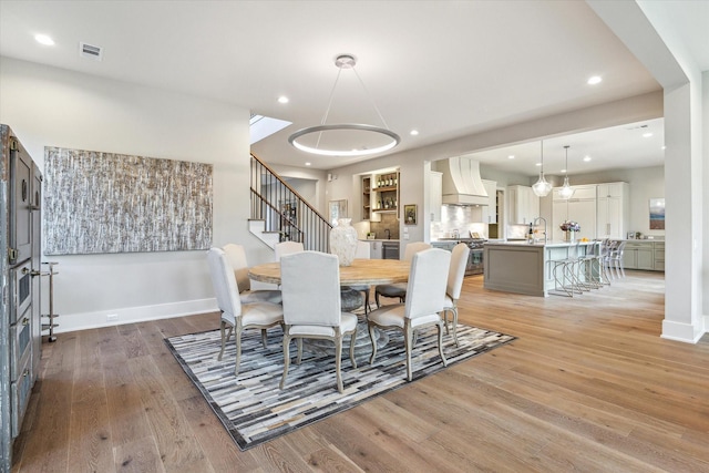1710 Ebony Ln, Houston, TX 77018 - dining area featuring light wood-type flooring, recessed lighting, and stairs
