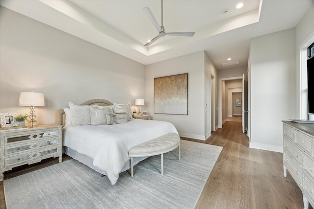 1710 Ebony Ln, Houston, TX 77018 - bedroom featuring wood finished floors, a tray ceiling, recessed lighting, and ceiling fan