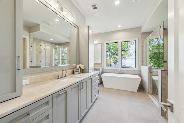 1710 Ebony Ln, Houston, TX 77018 - full bath with vanity, tile patterned flooring, a stall shower, a soaking tub, and recessed lighting