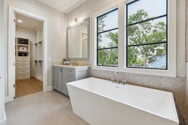 1710 Ebony Ln, Houston, TX 77018 - bathroom with healthy amount of natural light, a freestanding bath, vanity, and a walk in closet