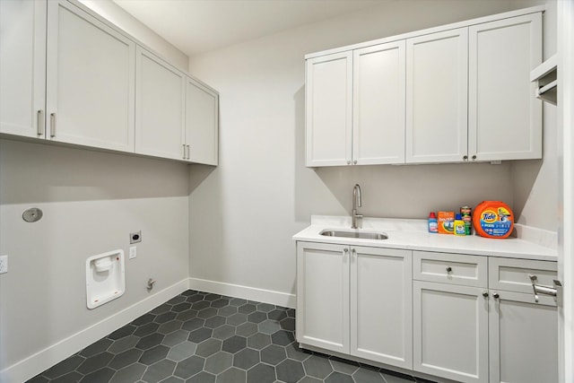1710 Ebony Ln, Houston, TX 77018 - laundry area with cabinet space, hookup for an electric dryer, and dark tile patterned floors