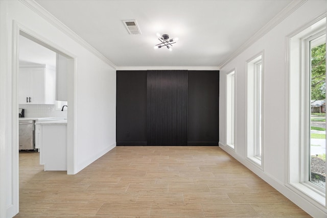 9711 Braewick Dr, Houston, TX 77096 - unfurnished room featuring crown molding and light wood-style floors