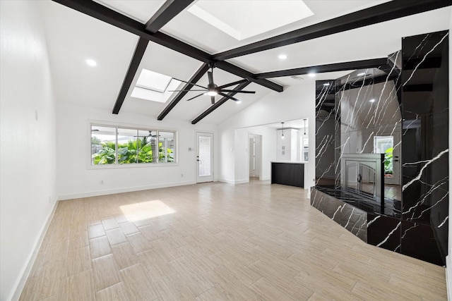 9711 Braewick Dr, Houston, TX 77096 - unfurnished living room featuring a skylight, a fireplace, wood finished floors, recessed lighting, and ceiling fan
