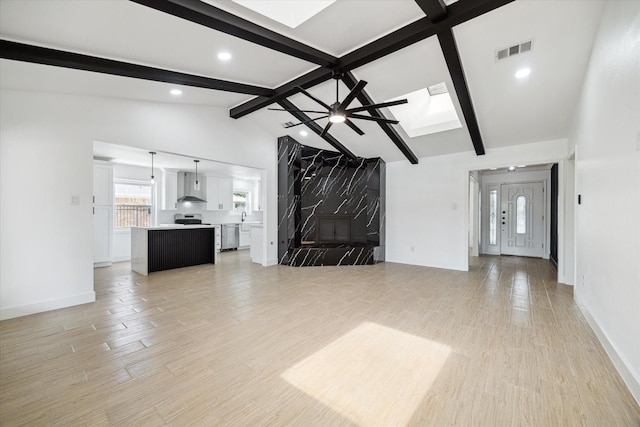 9711 Braewick Dr, Houston, TX 77096 - unfurnished living room with a skylight, light wood-type flooring, recessed lighting, and ceiling fan