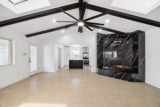 9711 Braewick Dr, Houston, TX 77096 - unfurnished living room with a skylight, recessed lighting, light wood-style flooring, and a ceiling fan