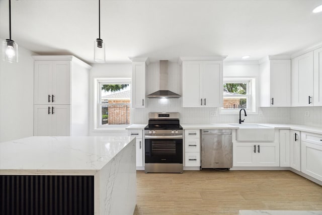 9711 Braewick Dr, Houston, TX 77096 - kitchen with stainless steel appliances, wall chimney range hood, decorative backsplash, plenty of natural light, and recessed lighting