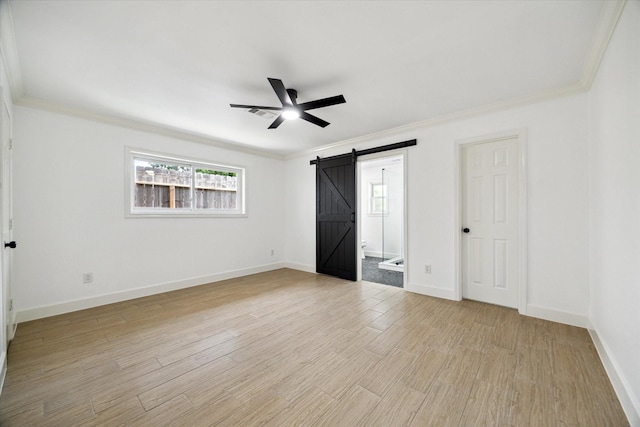 9711 Braewick Dr, Houston, TX 77096 - unfurnished bedroom with a barn door, crown molding, light wood finished floors, ensuite bath, and a ceiling fan