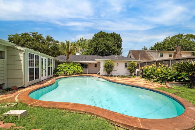 9711 Braewick Dr, Houston, TX 77096 - swimming pool with french doors and a patio area