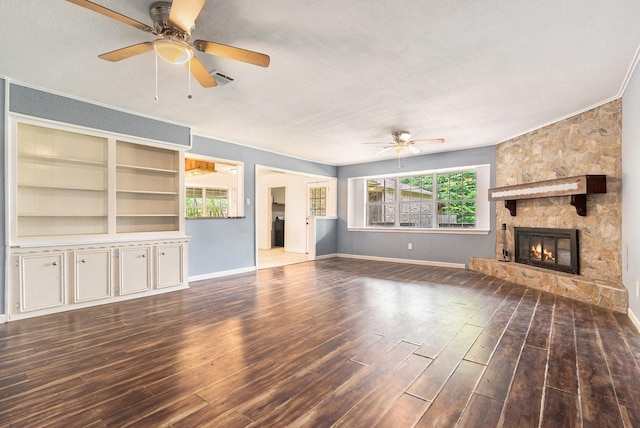 306 Hickory Ridge Dr, Shenandoah, TX 77381 - unfurnished living room featuring a ceiling fan, wood finished floors, a stone fireplace, and crown molding