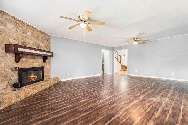 306 Hickory Ridge Dr, Shenandoah, TX 77381 - unfurnished living room with a ceiling fan, wood finished floors, stairway, a stone fireplace, and ornamental molding