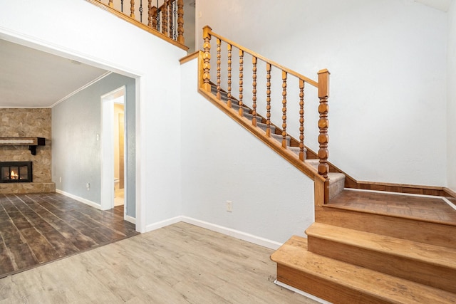 306 Hickory Ridge Dr, Shenandoah, TX 77381 - stairway with wood finished floors, ornamental molding, and a fireplace