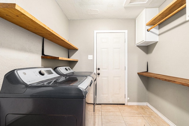 306 Hickory Ridge Dr, Shenandoah, TX 77381 - laundry room featuring washer and clothes dryer, light tile patterned floors, and a textured ceiling