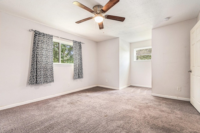 306 Hickory Ridge Dr, Shenandoah, TX 77381 - empty room with plenty of natural light, a ceiling fan, carpet floors, a smoke detector, and a textured ceiling