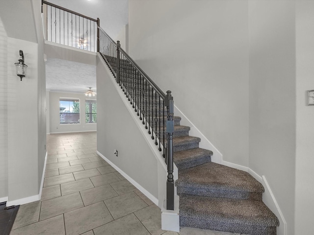 4315 Countrycrossing Dr, Spring, TX 77388 - stairs with tile patterned flooring, ceiling fan, and a high ceiling