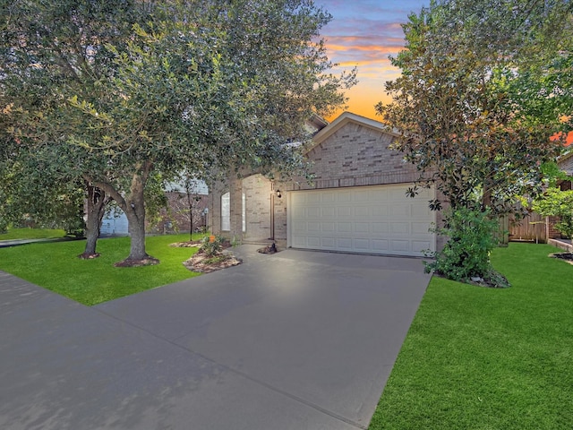 4315 Countrycrossing Dr, Spring, TX 77388 - view of property hidden behind natural elements with an attached garage, driveway, a front yard, and brick siding