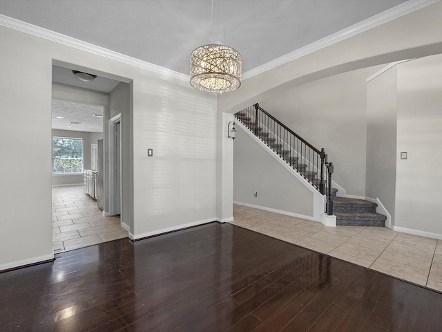 4315 Countrycrossing Dr, Spring, TX 77388 - entryway with wood finished floors, stairs, crown molding, and a chandelier