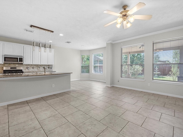 4315 Countrycrossing Dr, Spring, TX 77388 - kitchen with stainless steel appliances, decorative backsplash, open floor plan, light tile patterned flooring, and ceiling fan