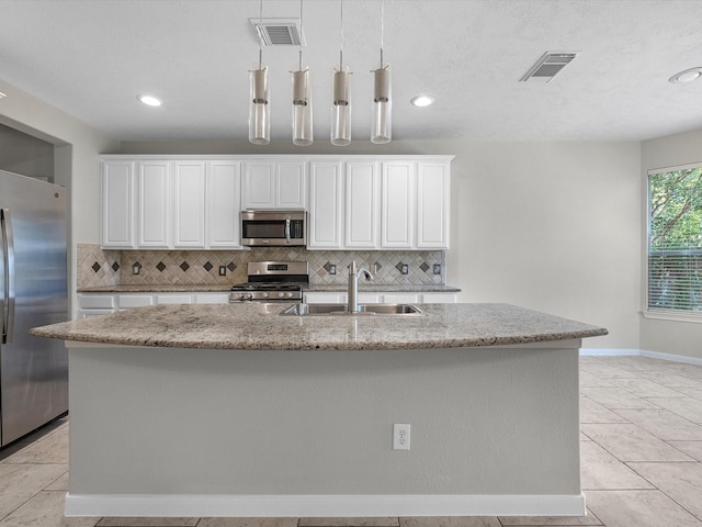 4315 Countrycrossing Dr, Spring, TX 77388 - kitchen featuring stainless steel appliances, tasteful backsplash, white cabinetry, and recessed lighting