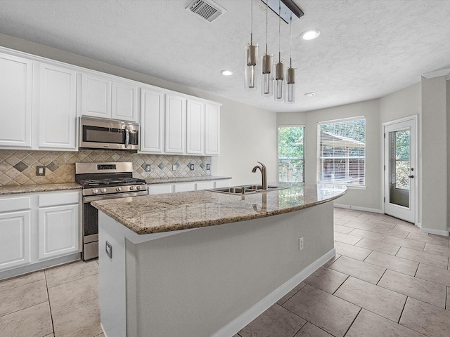 4315 Countrycrossing Dr, Spring, TX 77388 - kitchen featuring stainless steel appliances, backsplash, white cabinetry, recessed lighting, and a textured ceiling